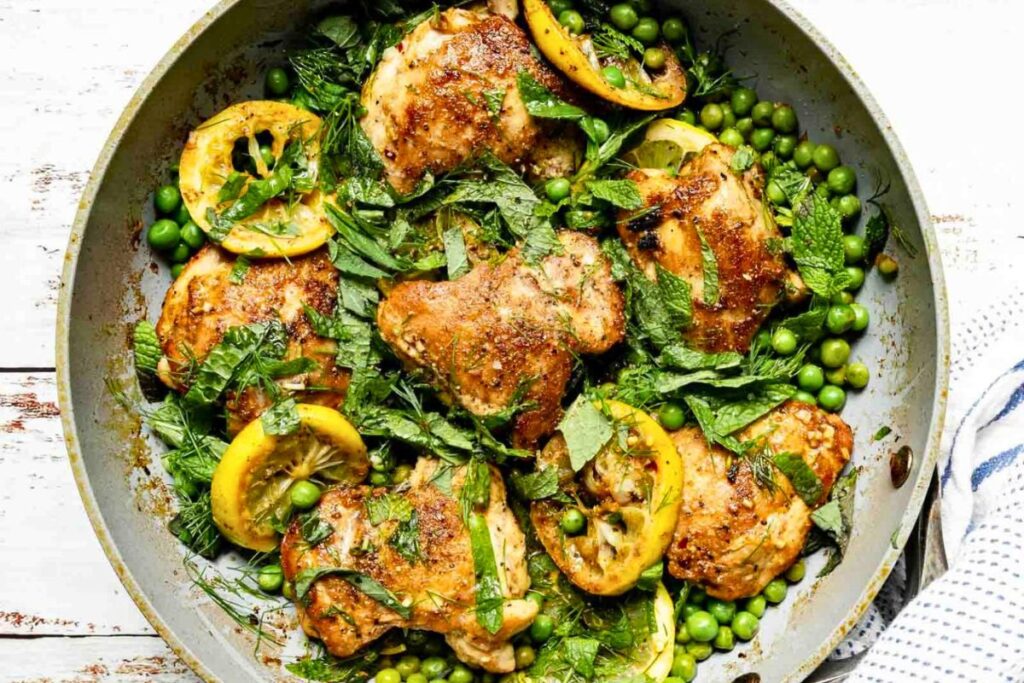 Easy Skillet Chicken and Peas With Fresh Herbs in a pan.